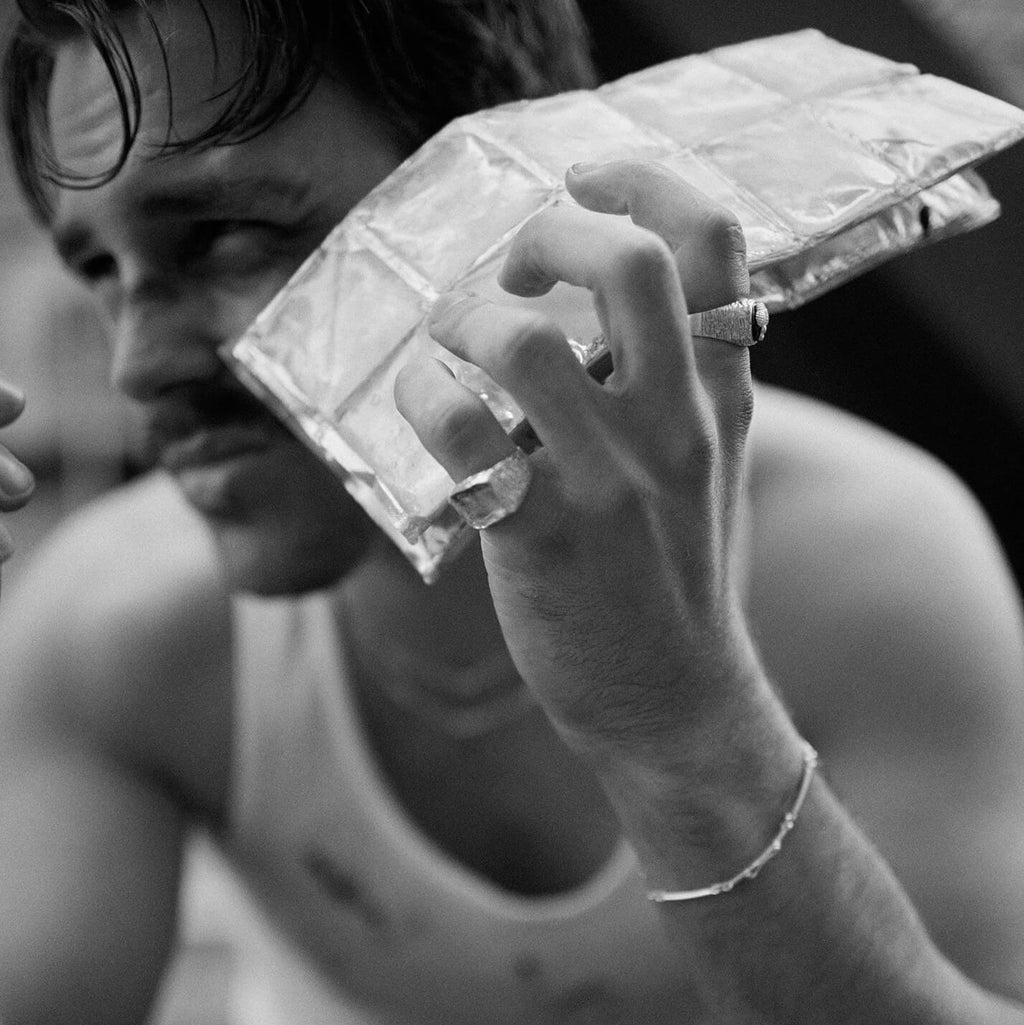 Person holding a transparent plastic block with a blurred background