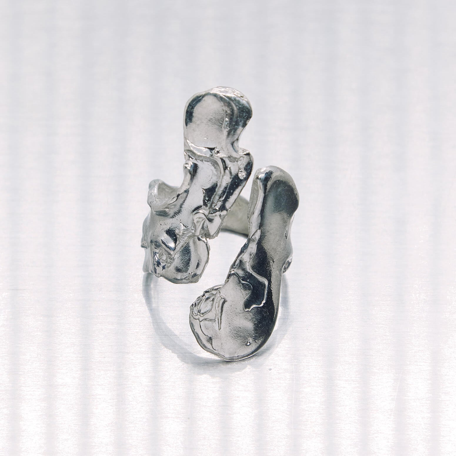 Silver ring with a unique design on a white background