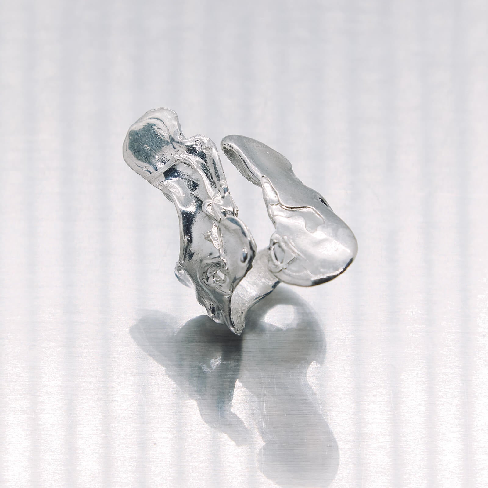 Silver ring with a diamond on a white background