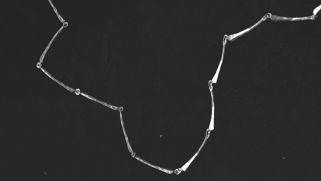 Silver necklace on a black background