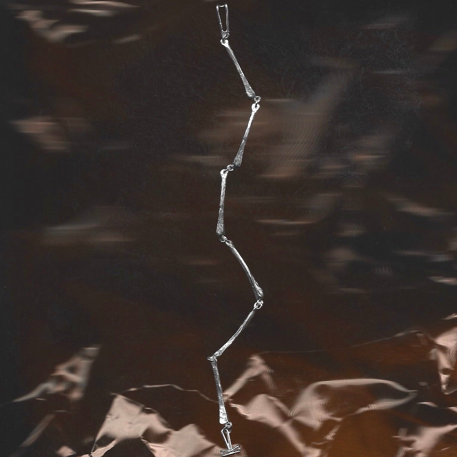 Metallic chain on a textured dark surface
