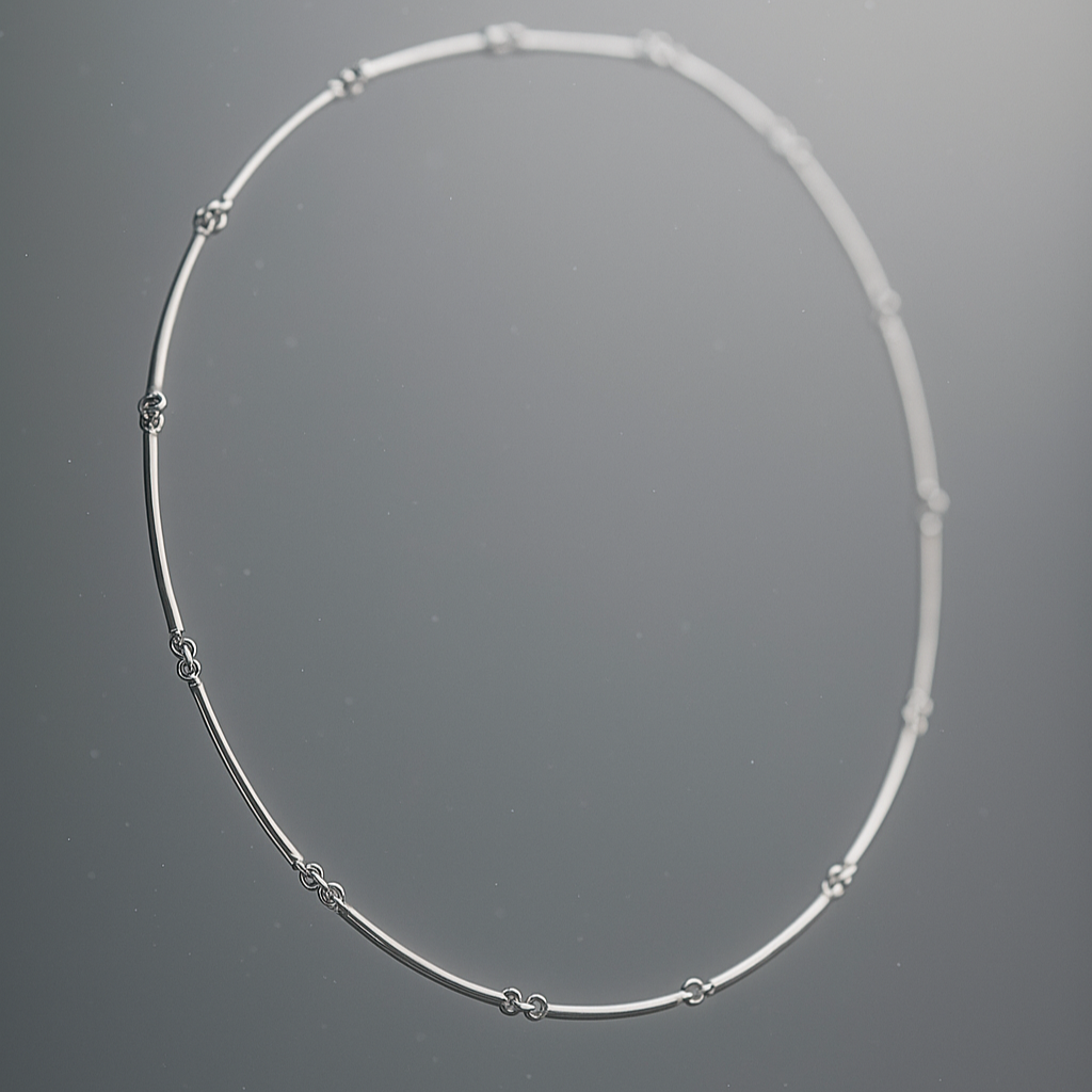 Silver necklace on a gray background