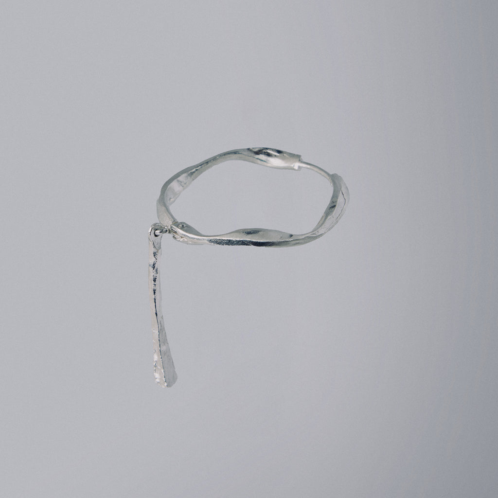 Silver bracelet on a gray background