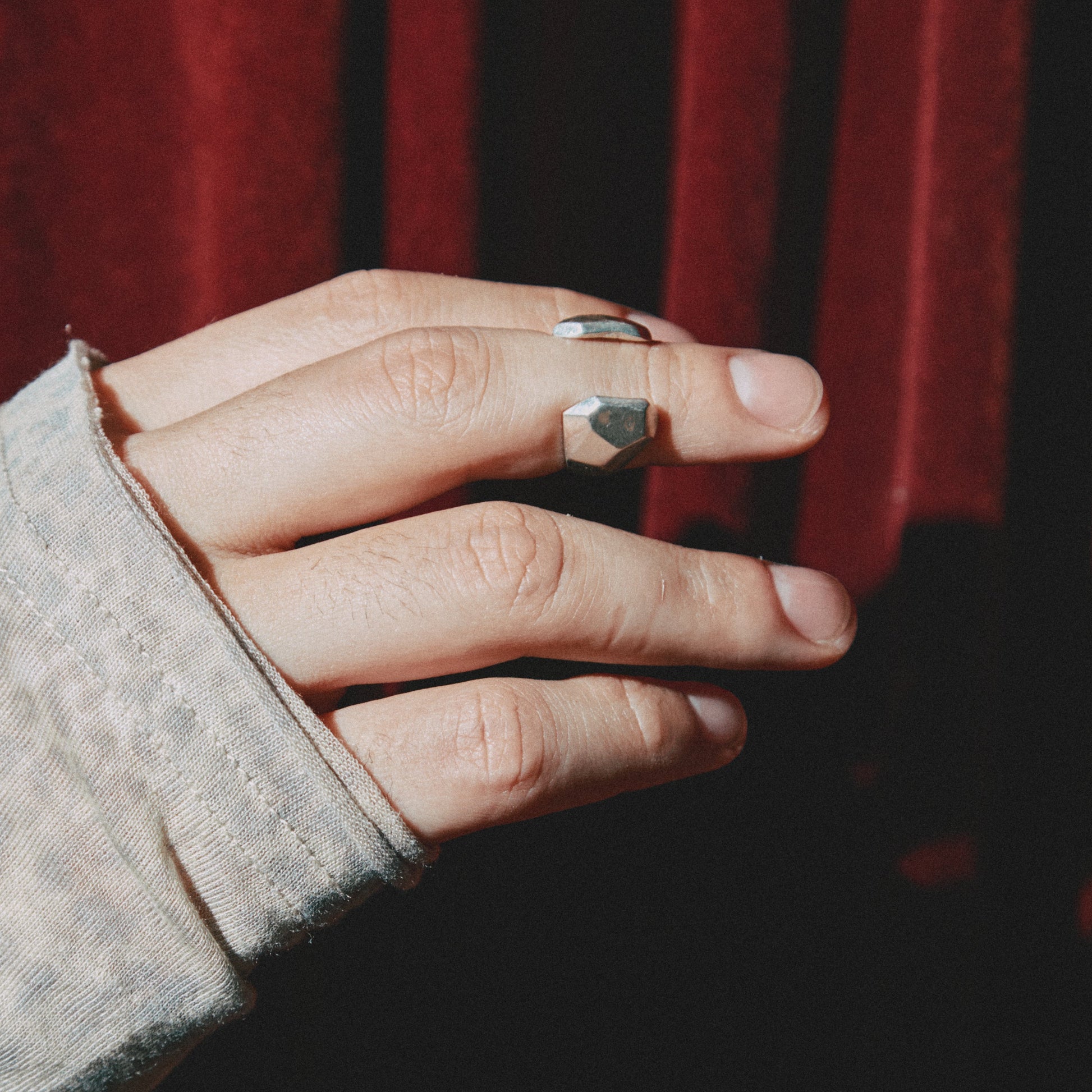 Hand with a ring on a dark background