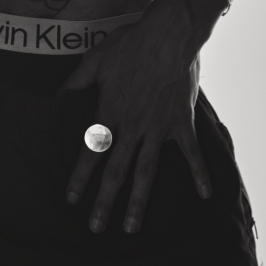 Person wearing a Calvin Klein belt with a close-up of the buckle.