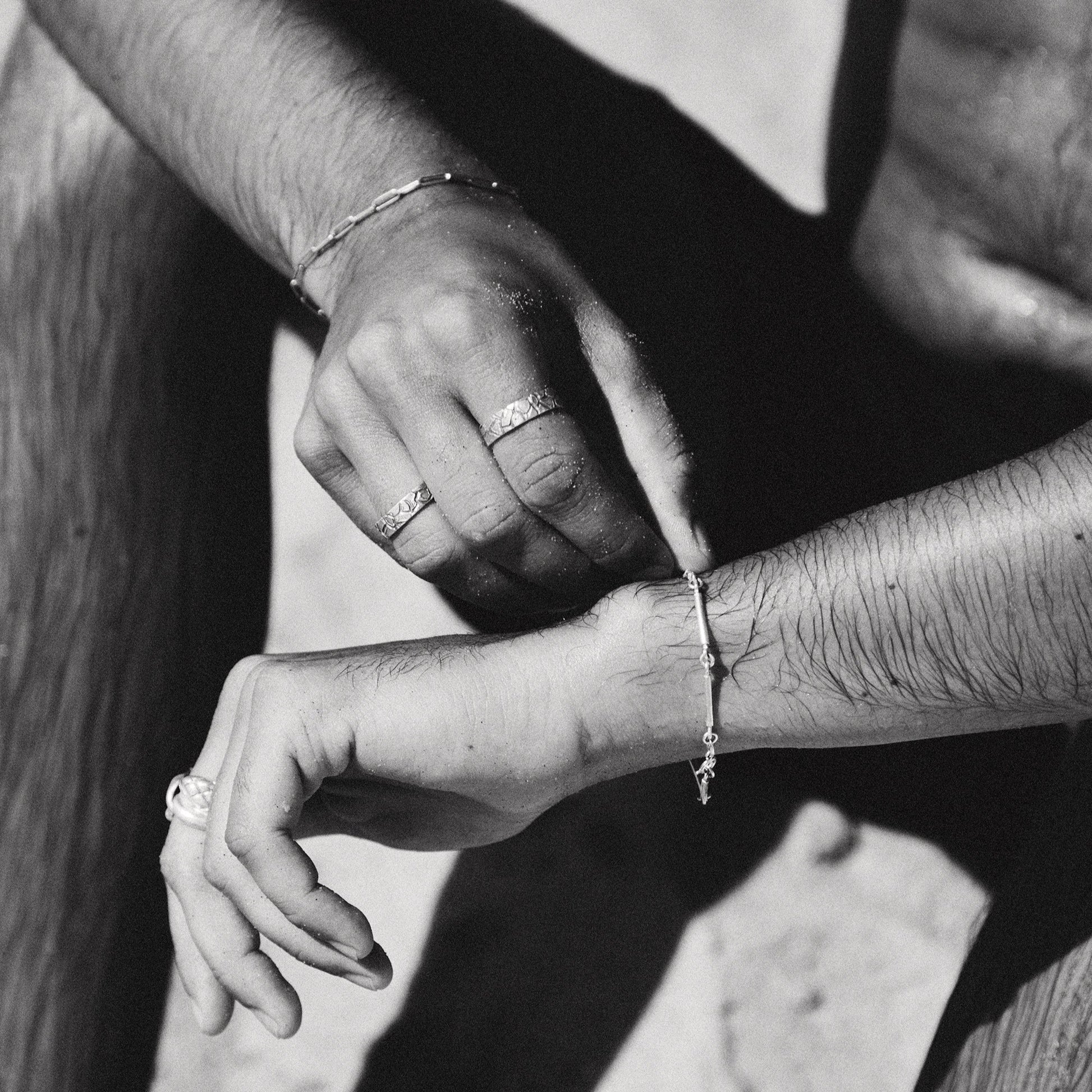 Close-up of hands with jewelry in a black and white photo
