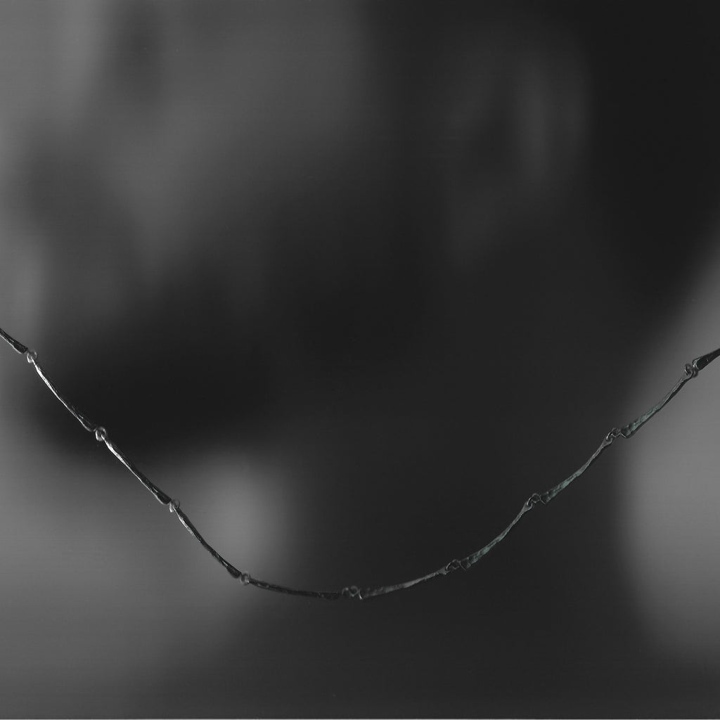 Silver necklace on a black background