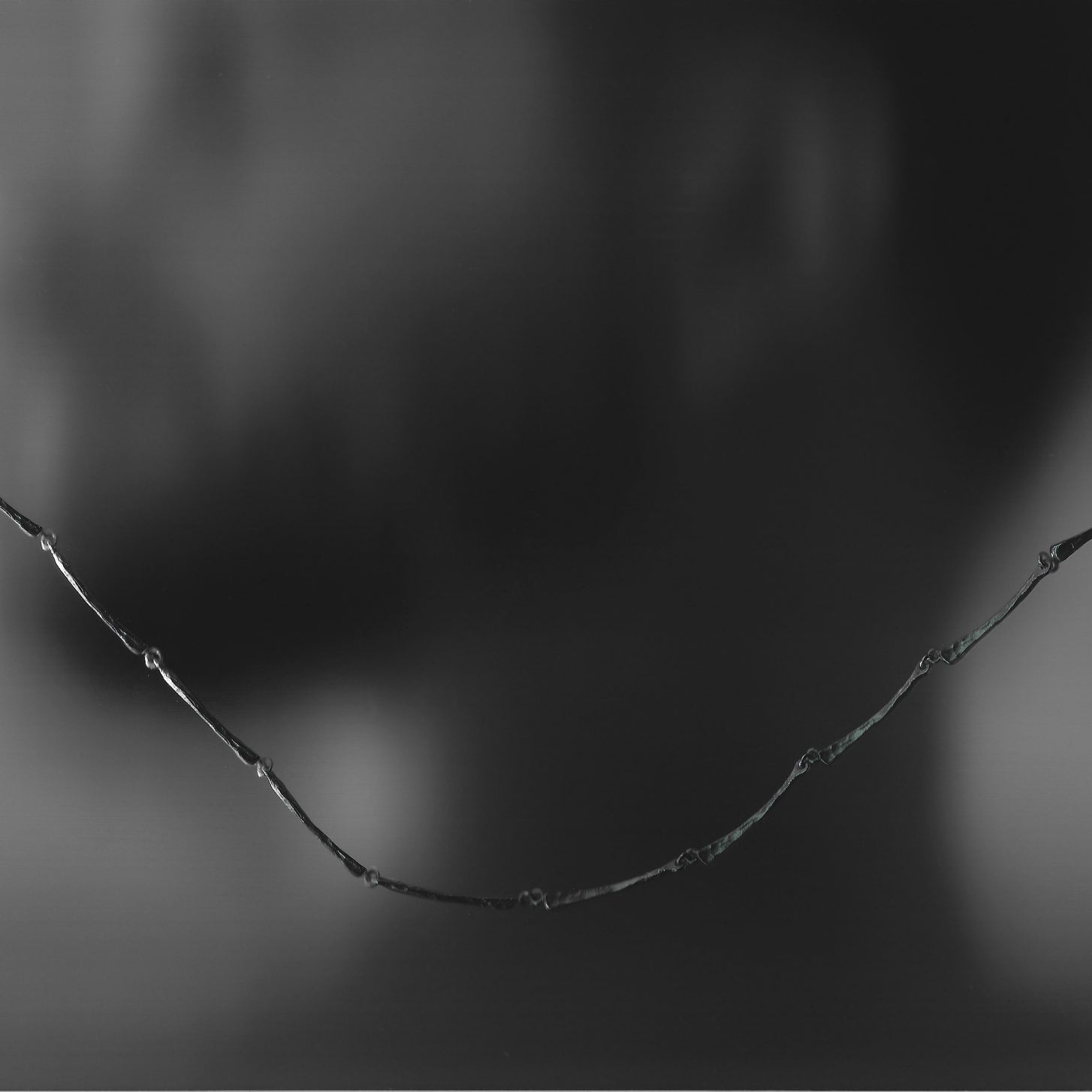Silver necklace on a black background