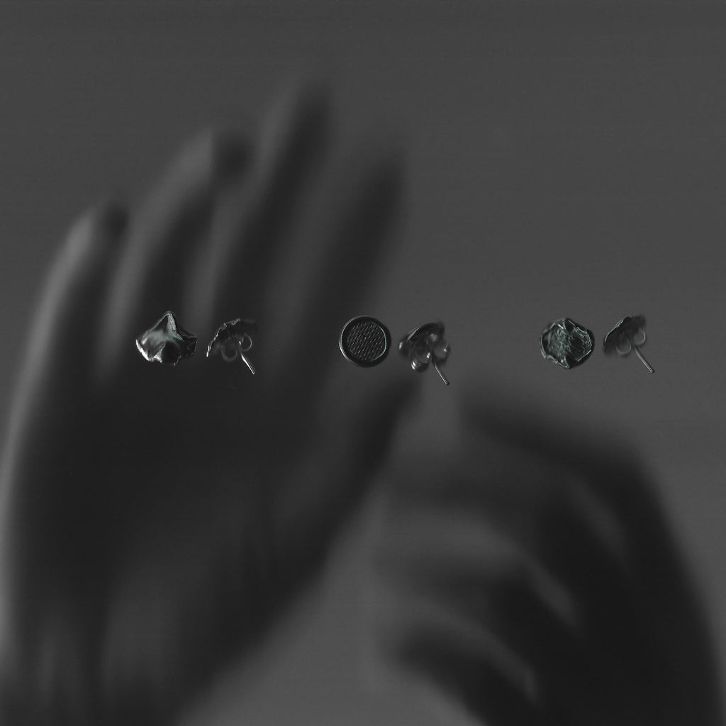 Set of six earrings displayed against a dark background