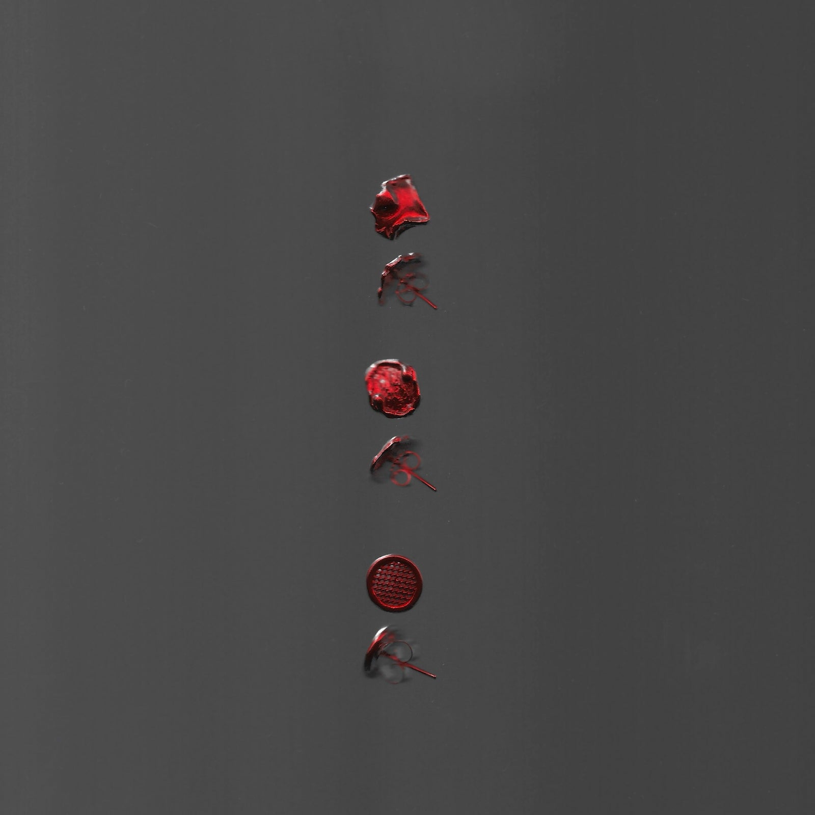 Red wax seals arranged vertically on a gray background