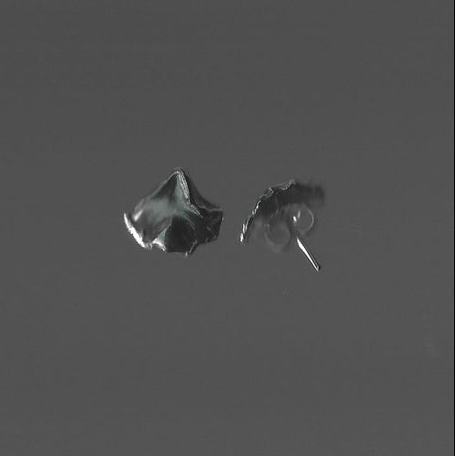Pair of silver earrings on a dark gray background
