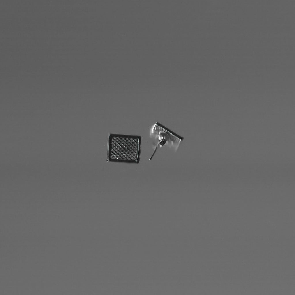 Two small square objects on a gray background