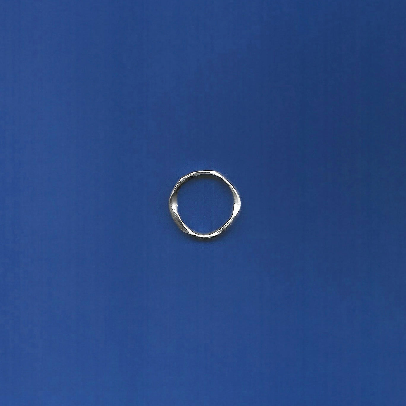 Silver ring on a blue background