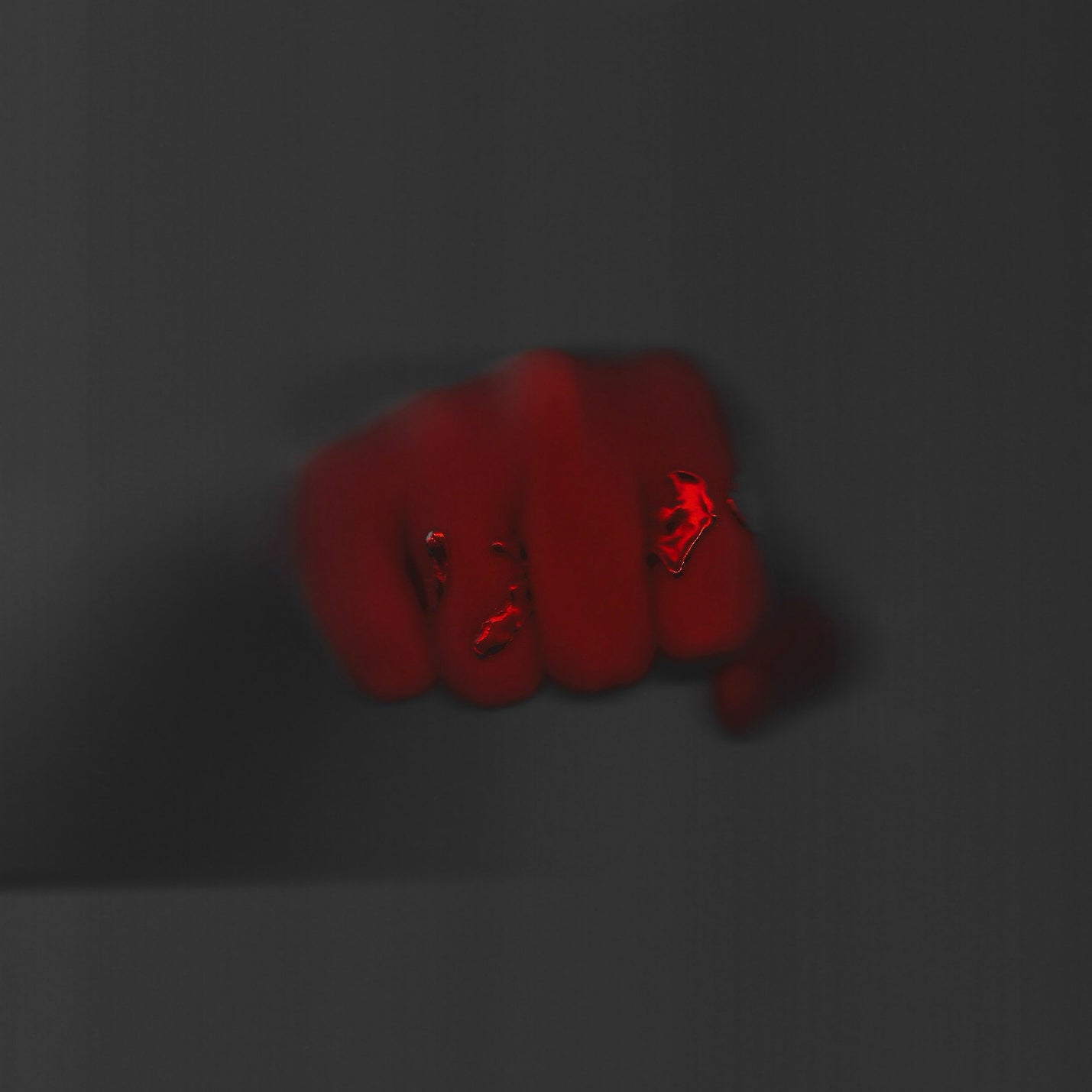 Red fist on a dark gray background