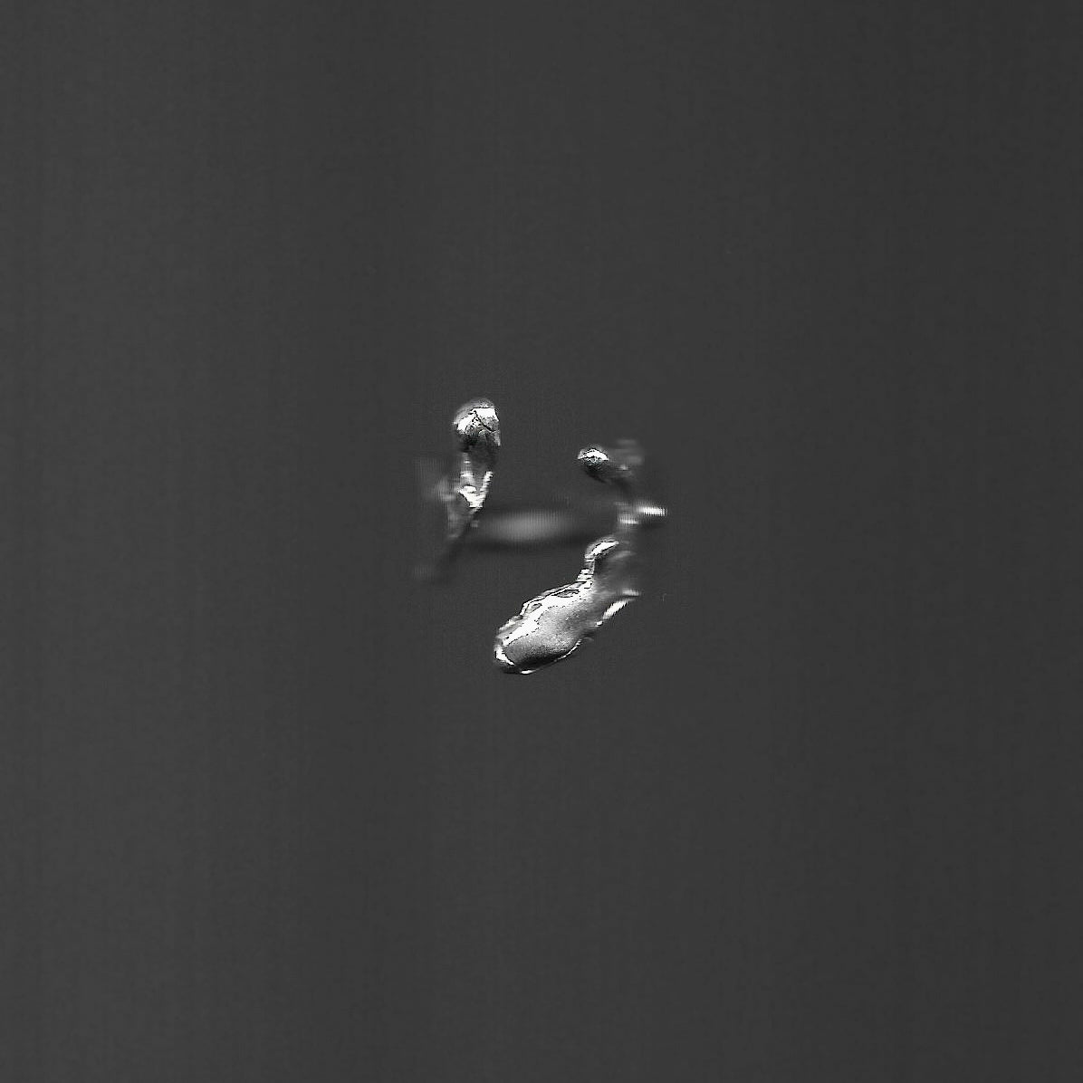 silver ring on a dark surface