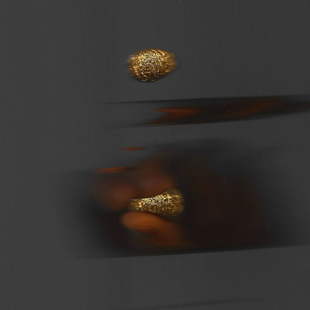 Gold ring on a dark gray background