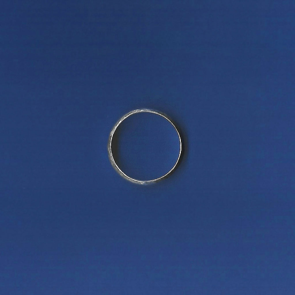 Silver ring on a blue background