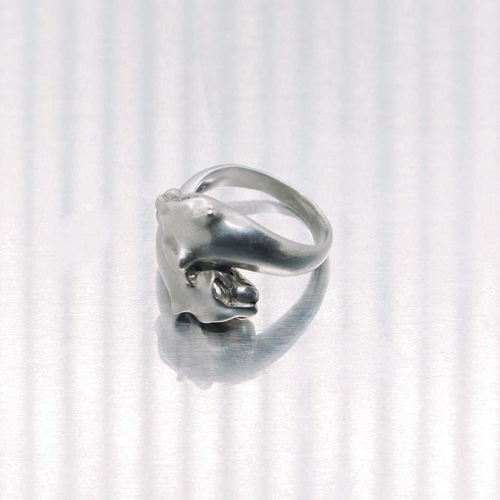 Silver ring with a tiger design on a white background