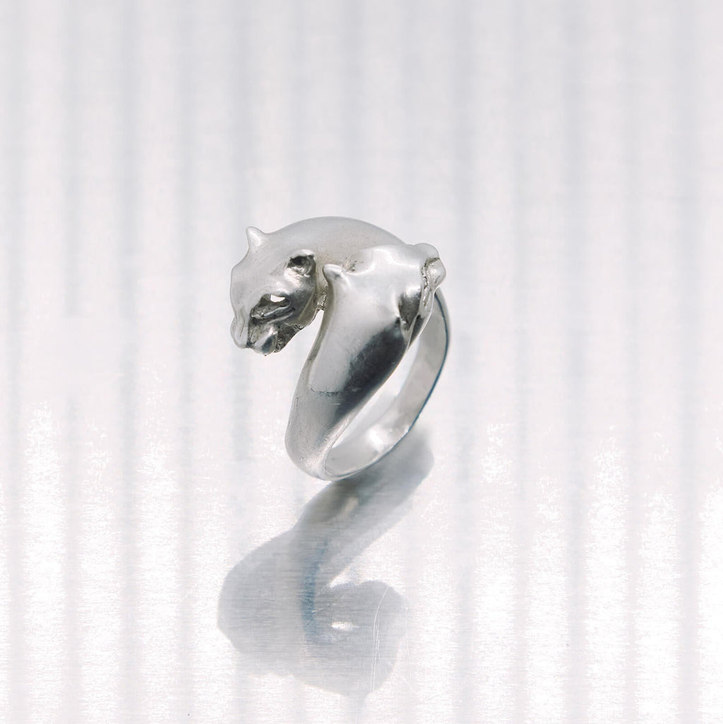 Silver ring with a tiger head design on a white background