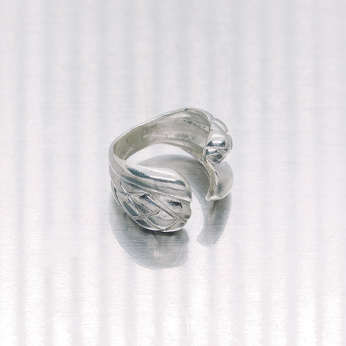 Silver ring with a unique design on a white background