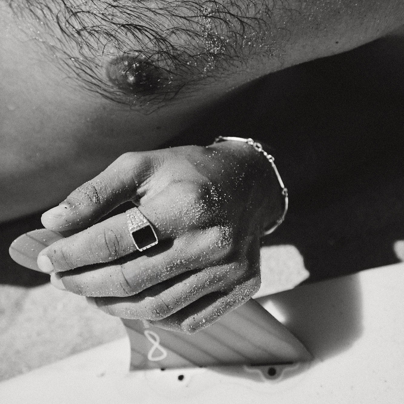 Close-up of a person's hand with a ring on a blurred background